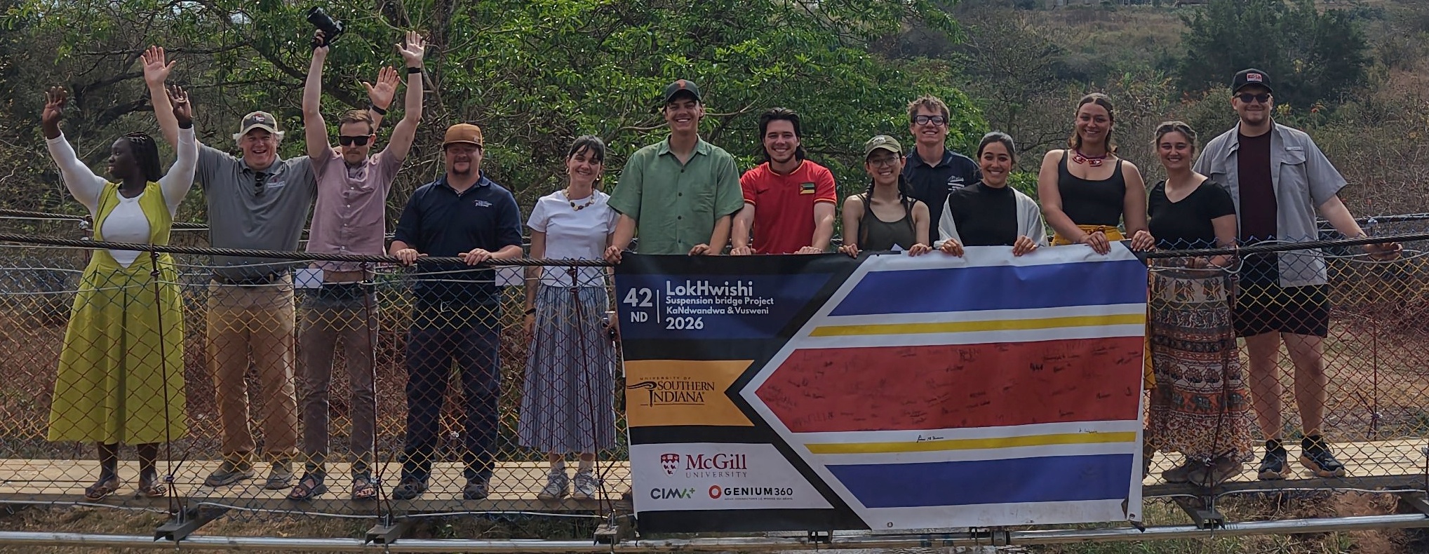 The 2026 bridge team holding the Lokhwishi banner with sponsor logos